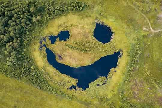 An aerial photograph of a lake in Russia.  It looks like a face and the blog is about Its a face! No, it's not, its pareidolia!
